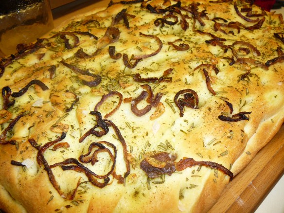 hot focaccia with fresh rosemary, carmelized red onions, garlic slices - topped with maldon sea salt and freshly cracked pepper