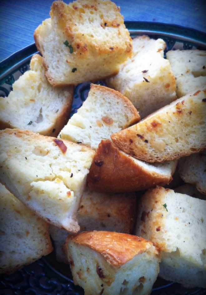 Torn garlic bread is crunchy and soft all at the same time.