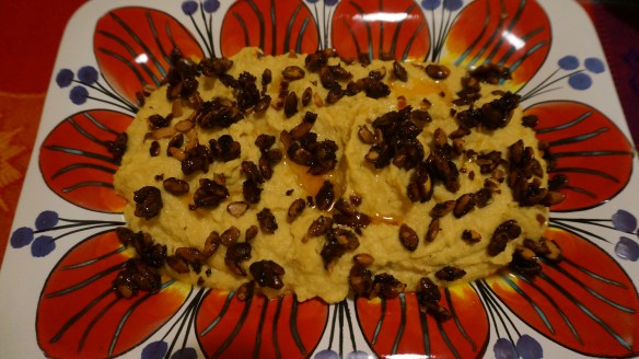 Crunchy carmelized pumpkin seeds and a drizzle of chile oil make this creamy hummus a fabulous appetizer!